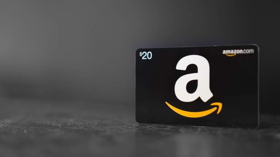 Amazon gift card standing upright on dark table