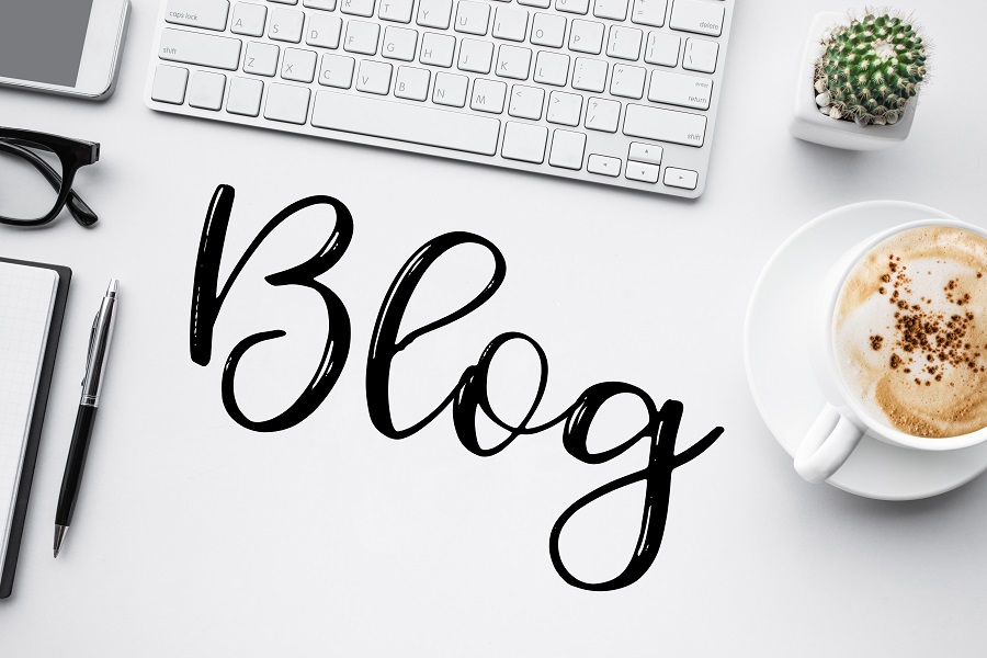 The word blog on top of a minimalist white desk
