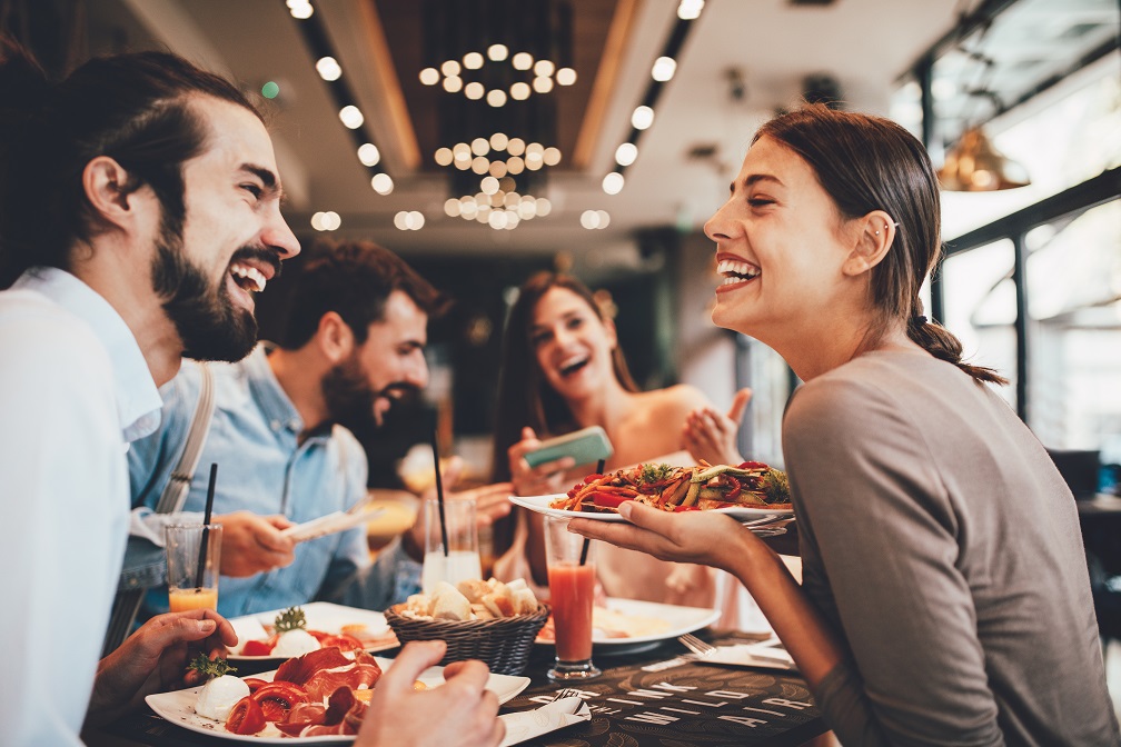 Group of people enjoying themselves at a restaurant