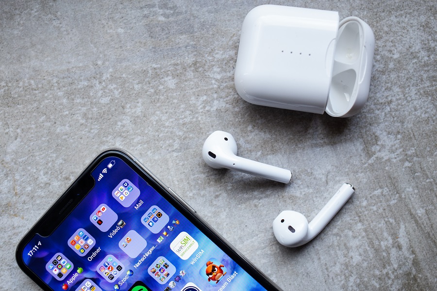 iPhone and Airpods on top of table
