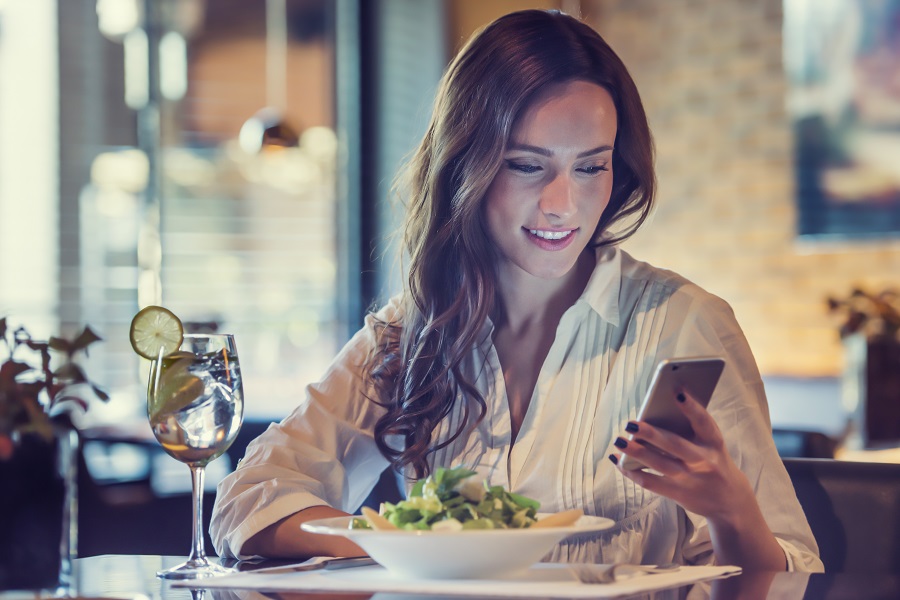 Woman looking at her phone in a restaurant