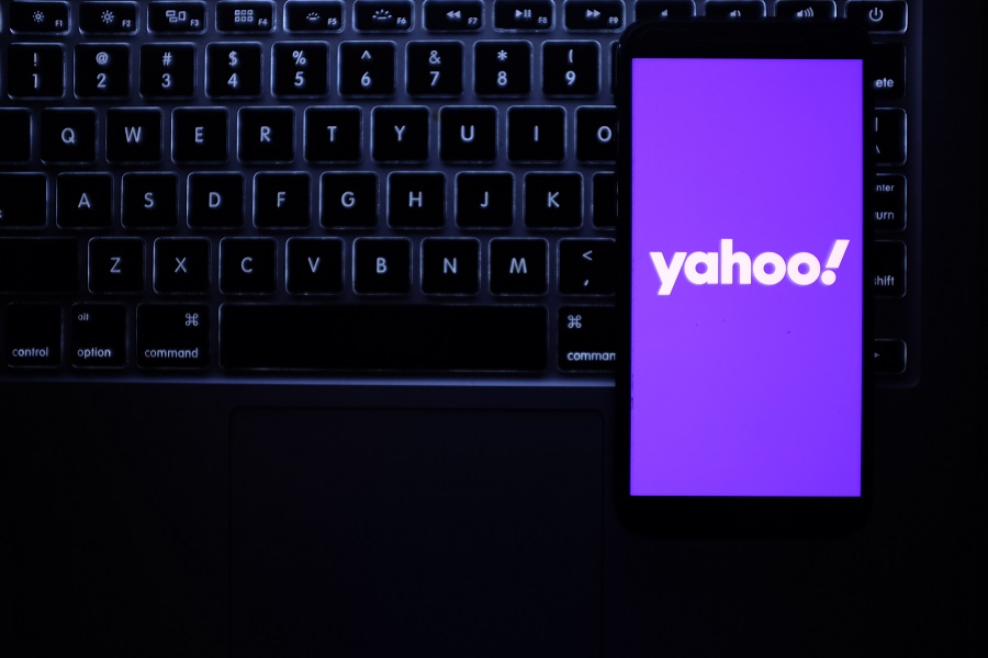 Yahoo logo on phone with keyboard in background