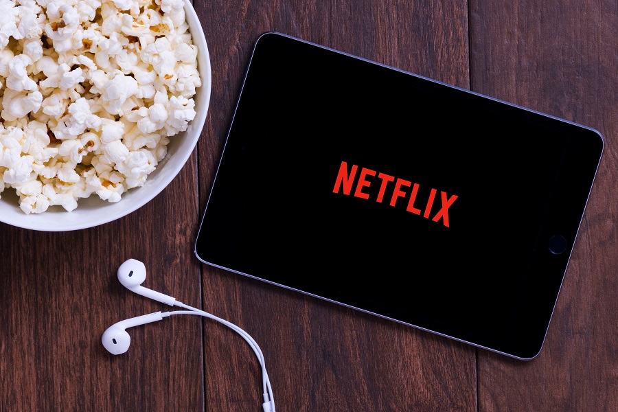 Netflix and popcorn on wooden table