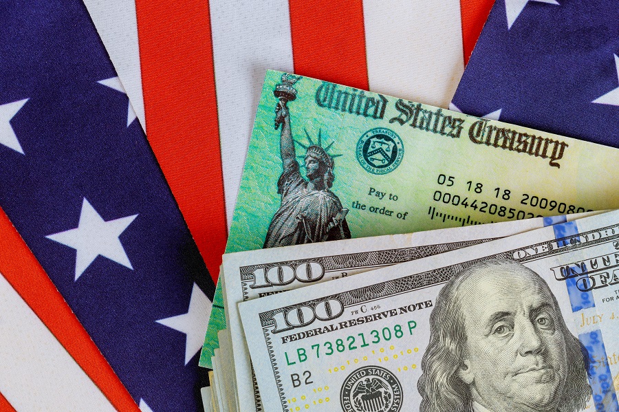 Treasure checks and money against US flag background