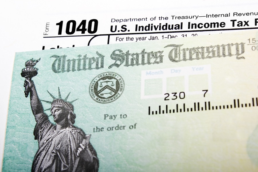 IRS check with 1040 form in the background
