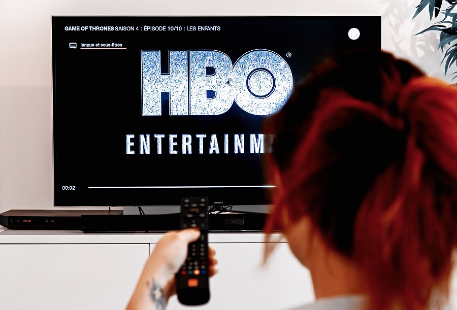 Woman viewing HBO logo on TV