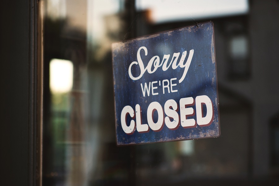 "Sorry we're closed" sign on window