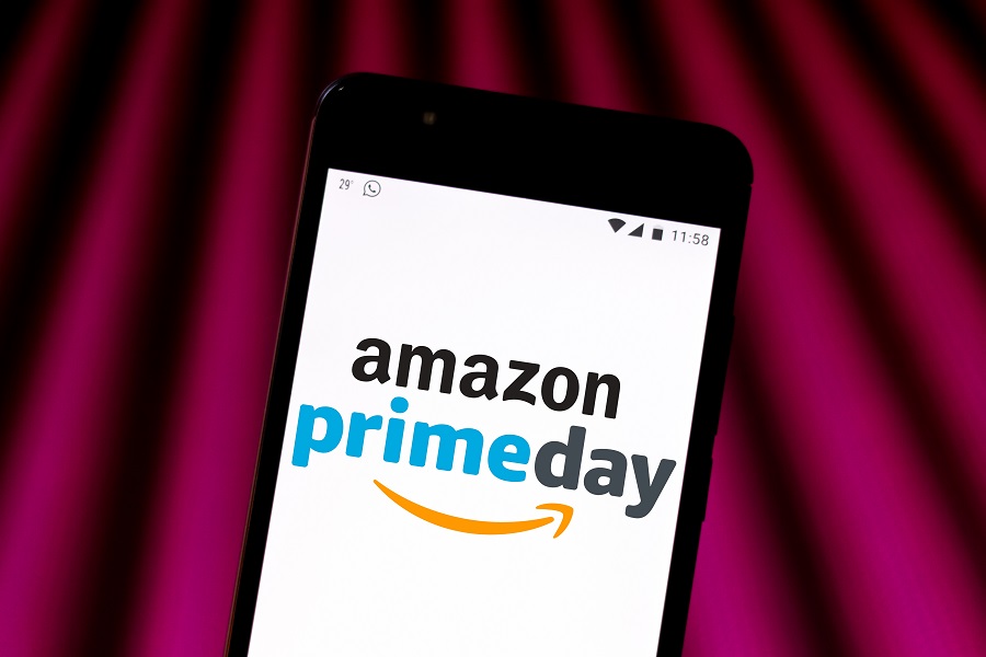 Amazon Prime Day logo on phone with purple beam background
