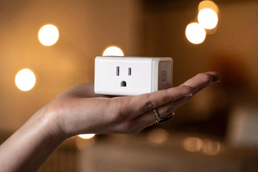 Kasa smart plug mini on woman's hand