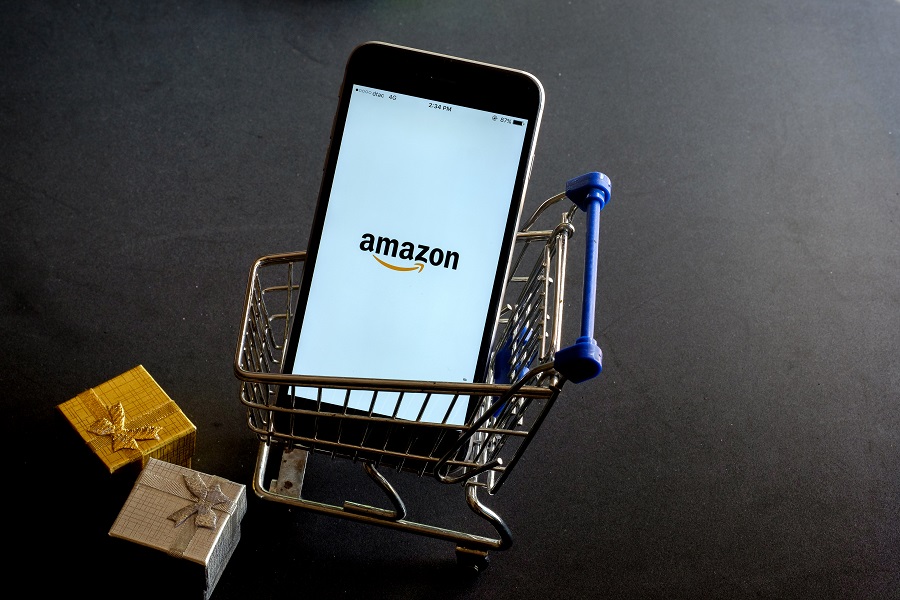 Amazon app on phone inside mini shopping cart