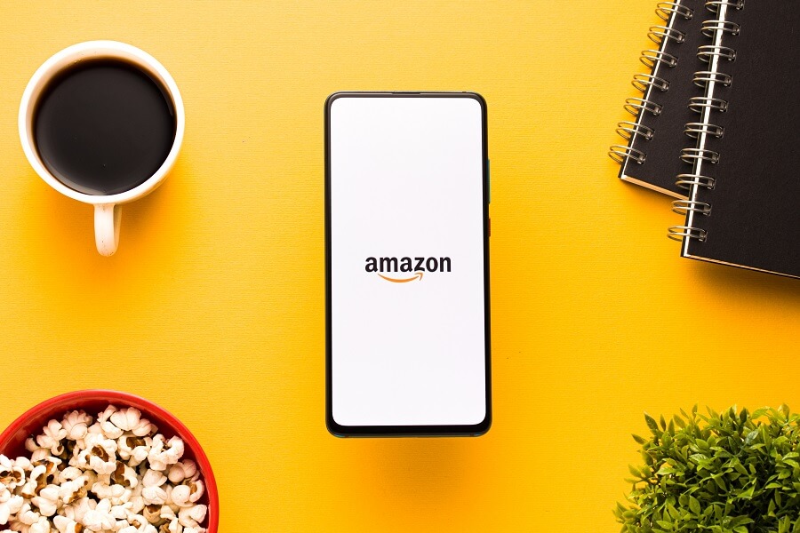 Phone with Amazon logo against yellow background