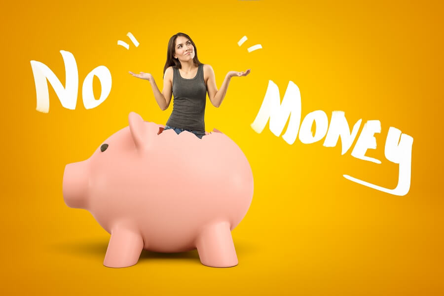 "No Money" words with woman in an empty piggy bank