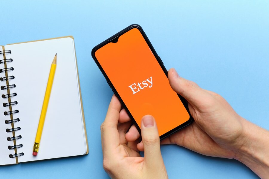 Etsy logo on phone with blue background