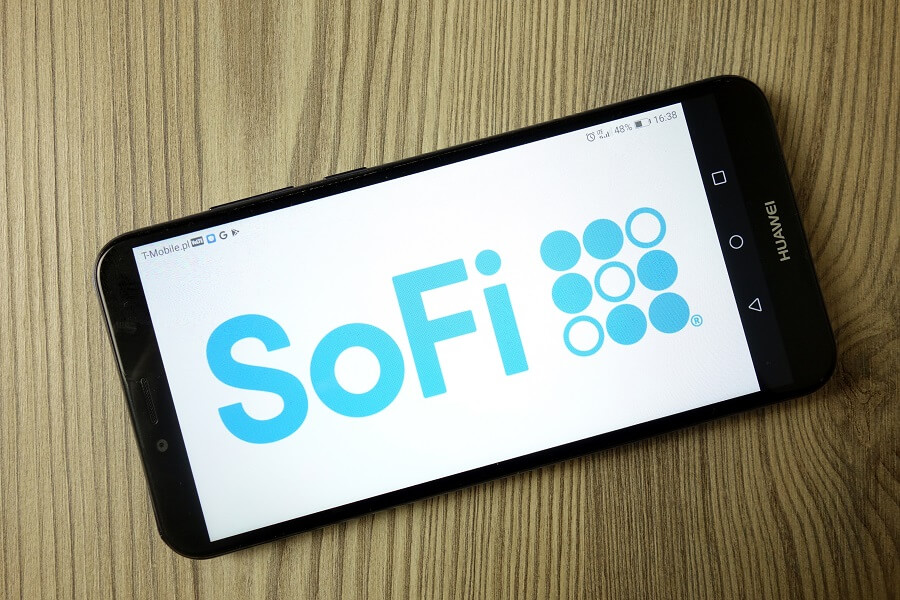 SoFi logo on mobile phone on wooden desk
